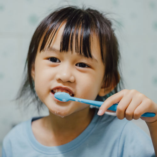 child brushing teeth