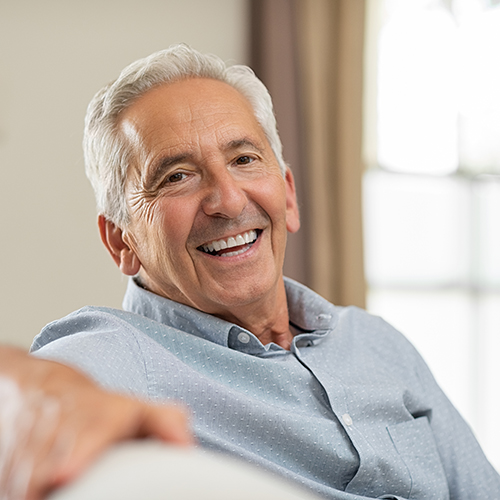 Senior man smiling at home